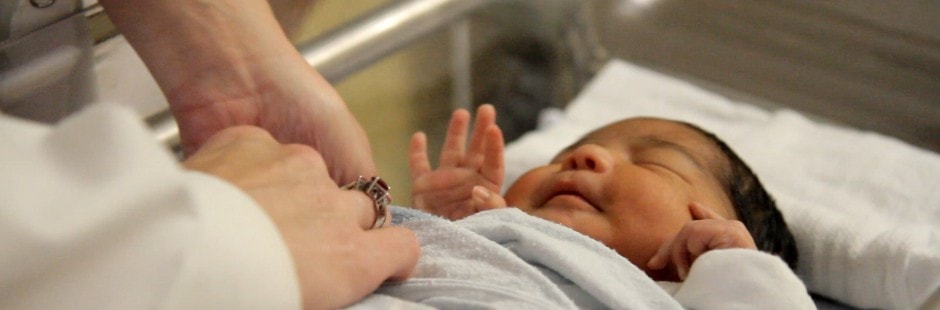 nurse-tending-to-baby-closeup1-940x3101-min
