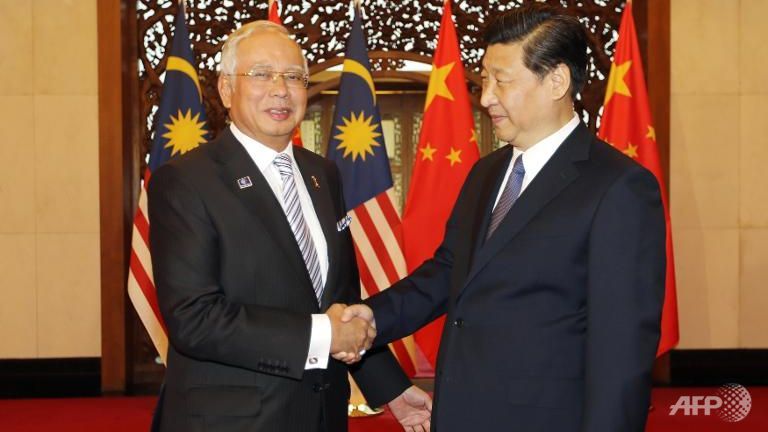 malaysia-s-prime-minister-najib-razak-l-shakes-hands-with-min